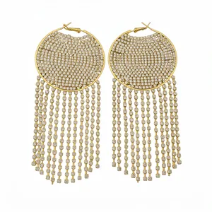 Elegant gold-tone round hoop earrings with sparkling rhinestone tassels and silver pins.