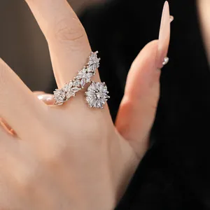 Close-up of elegant V-shaped flower ring with sparkling cubic zirconia on a hand model