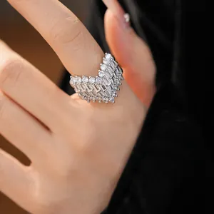 Close-up detail of an exquisite V-shaped ring inlaid with sparkling white zircons