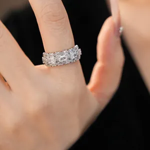Close-up detail of a luxurious wide band ring featuring rows of sparkling clear zircons