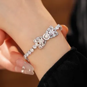 Elegante zilveren strik armband met fonkelende zirkonia en witte parel voor dames
