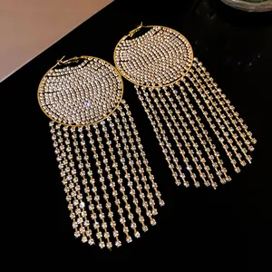 Close-up of sparkling rhinestone circular earrings with elegant long tassel fringes