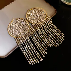Detailed close-up of luxury sparkling rhinestone tassel hoop earrings in gold finish