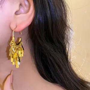 Sophisticated gold-tone geometric tassel drop earrings with unique designer style for women