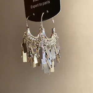 Elegant silver metallic geometric fringe earrings with chic tassel pendant design