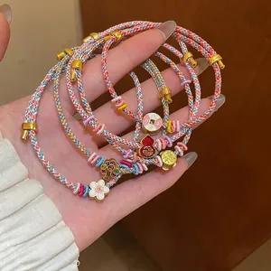 Hand-woven colorful cord bracelets with flower and gourd charms in a gold-plated finish