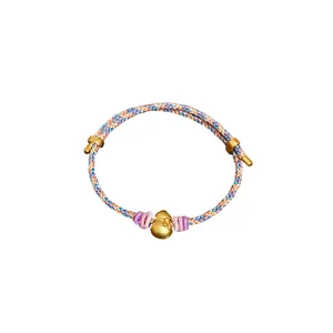 Handmade woven cord bracelet featuring a matte gold gourd charm and adjustable sliding knots