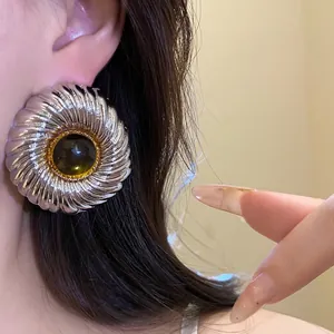 Elegant vintage silver textured round stud earrings with an amber resin center