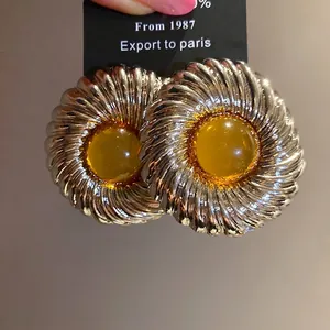 Elegant vintage silver needle round earrings with ribbed texture and amber resin center