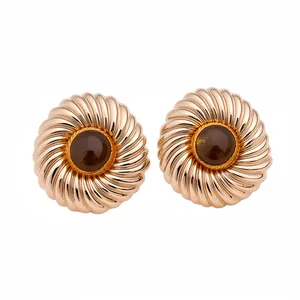Elegant round textured gold stud earrings with dark amber resin center for modern women