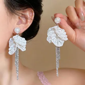 Elegant pearl and white petal tassel earrings for a vacation look
