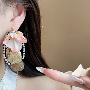 Detail shot of acrylic flower petal earrings with metallic leaves and clear beads
