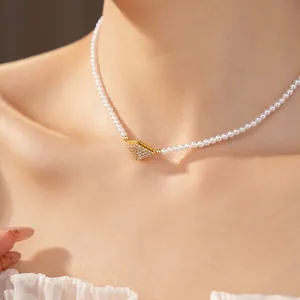 Detailed close-up of an elegant pearl choker with a zircon-encrusted diamond pendant
