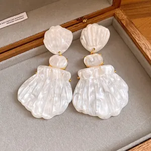 Detail of French vintage shell pendant earrings in a jewelry box