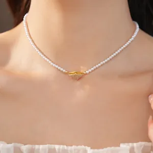 Close-up of a zircon geometric pendant on a white pearl necklace worn on the neck