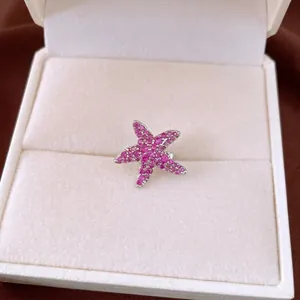 Sparkling pink zircon starfish ear clip for non-pierced ears in a beige jewelry gift box