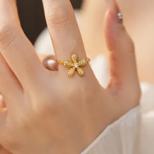 Detailed macro view of an elegant sparkling gold flower ring with micro-paved diamonds