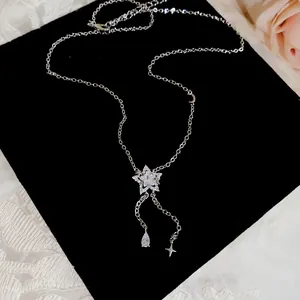 Close-up of elegant silver star necklace with zircon waterdrop tassels