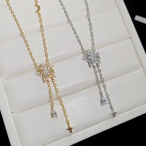 Detail view of zircon star and waterdrop tassel necklaces in gold and silver finish