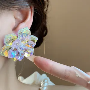 Vue macro détaillée de boucles d'oreilles fleurs en verre irisé avec une texture cristal éclatante.