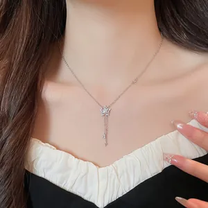 Detailed view of a sparkling zircon star pendant necklace with delicate tassel chains.
