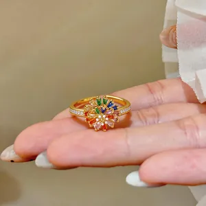 Close-up detail of an 18k gold plated adjustable ring with a vibrant zirconia flower