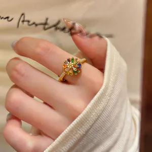 Close-up of 18k gold plated ring featuring a colorful zircon flower design on hand