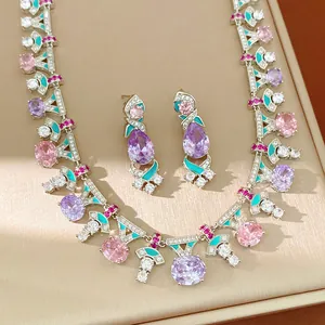 Close-up of vintage jewelry set with colorful zircons and turquoise enamel