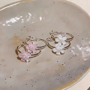 Detail of sweet resin flower hoop earrings in pink and white petals for women