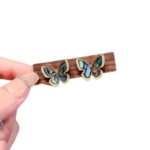 Elegant vintage abalone shell butterfly stud earrings with shiny micro-pave cubic zirconia