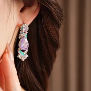 Detail view of ornate palace-style earring with purple pear-shaped zircon and teal enamel