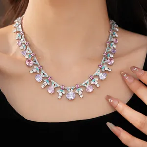 Detail view of a palace style enamel necklace with pink and purple oval CZ stones.