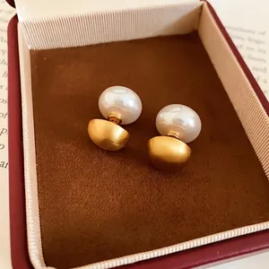 Elegant double-sided earrings with white pearl and matte gold brushed metal finish.