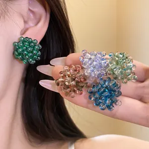 Handmade colorful beaded floral stud earrings with S925 silver needles worn by a model