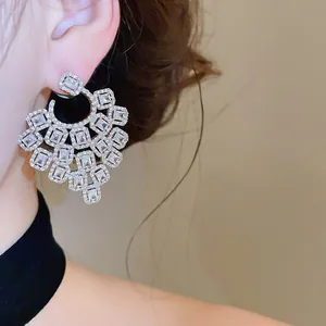 Detail view of luxe hollow zircon tassel earrings on a model, elegant party style