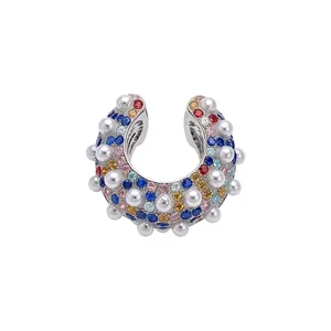 Elegant silver ear cuff decorated with multi-colored rhinestones and pearls in horseshoe shape
