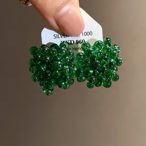 Close-up view of handcrafted green beaded cluster stud earrings with S925 silver needle