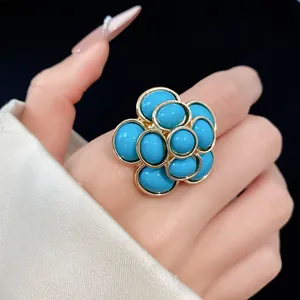 Close-up detail of a vintage palace style flower cocktail ring with blue resin stones