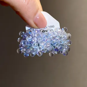 Close-up of deep sea blue beaded flower stud earrings with S925 silver needle
