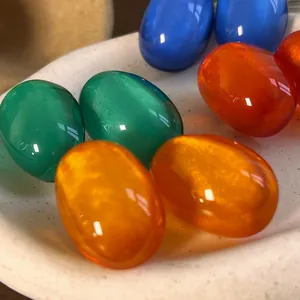 Detail shot of vibrant dopamine-colored oval resin components for vintage stud earrings