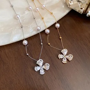Elegant 18k gold plated necklace featuring zircon flower pendant and pearl accents