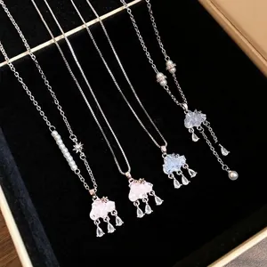 Exquisite cloud necklaces with pearl beads and zircon water drop tassels displayed in a box