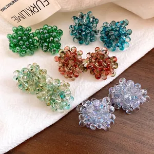 Close-up detail of exquisite colorful translucent glass bead cluster flower stud earrings