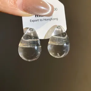 Detailed macro shot highlighting the clear crystal texture of teardrop earrings