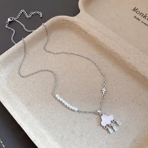 Detail showing the cloud-shaped pendant with pearls and zircon water drop tassels