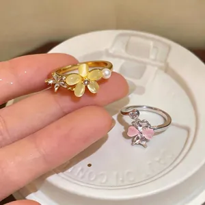 Elegant rotating zircon flower rings with adjustable bands in gold and silver finishes