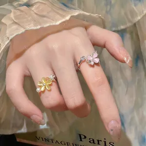 Elegant sweet style zircon flower and butterfly spinning open rings on hand model