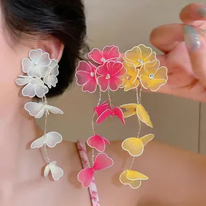 Detail of handmade mesh floral earrings in white, pink and yellow variants
