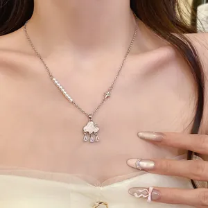 Detailed view of a sweet cloud necklace with pearls and sparkling zircon tassels.