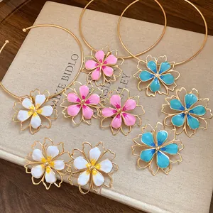 Detail view of colorful enamel hollow flower pendants for necklaces and earrings.